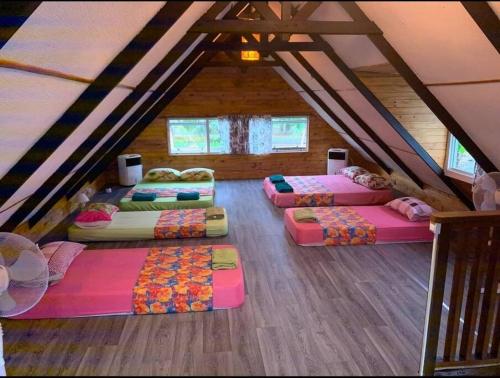 a attic room with five beds in a attic at FARE AHIATA MOOREA in Moorea