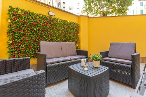 two chairs and a table on a patio at Imperium House - appartamento con giardino privato a 3 minuti da Metro Piazza Bologna in Rome