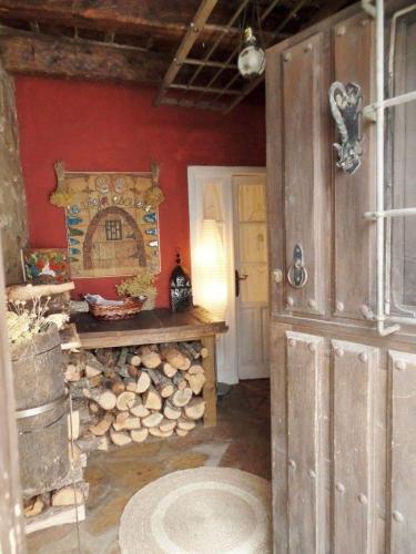 a room with a pile of fire wood and a fireplace at La Vieja Escuela in Fuentes de Rubielos