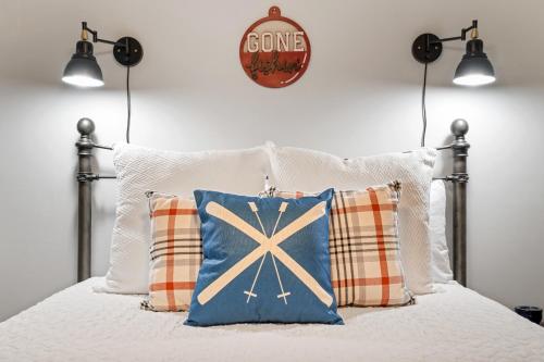 a bed with two pillows and a sign on the wall at No Dog Fees - Dog Friendly 3BR 2BA with Loft and Mountain Views - Near Bryce Resort in Basye, VA in Basye
