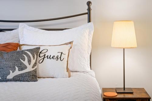 a guest bedroom with a guest pillow on a bed with a lamp at No Dog Fees - Dog Friendly 3BR 2BA with Loft and Mountain Views - Near Bryce Resort in Basye, VA in Basye