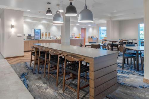 a kitchen and dining room with a large table and chairs at Fairfield Inn & Suites Rapid City in Rapid City