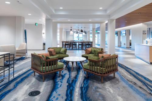a hotel lobby with two chairs and a table at Fairfield Inn & Suites Rapid City in Rapid City