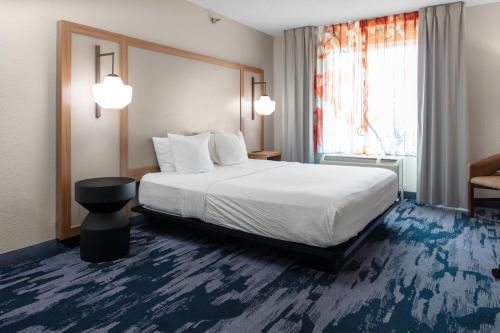 a hotel room with a large bed and a window at Fairfield Inn & Suites Rapid City in Rapid City