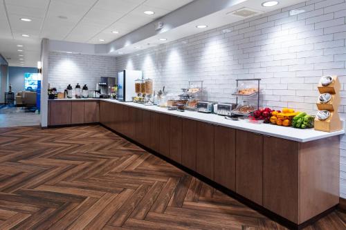 a restaurant with a counter with food on it at Fairfield Inn & Suites Rapid City in Rapid City