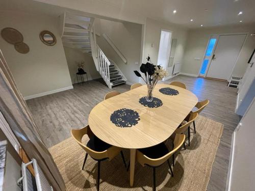 a dining room with a wooden table and chairs at Noah Longstay Liljanstorpsvägen in Västerås