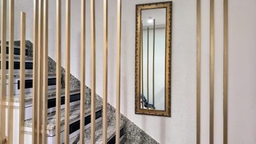 a mirror on a wall next to a stair case at Little House in Center in Almería
