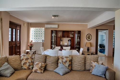 a living room with a couch and a dining room at Petronas Villa in Kariá