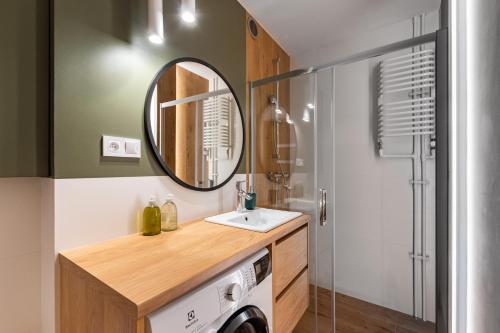 ein Bad mit einem Waschbecken und einem Spiegel in der Unterkunft Apartament Jasna by Your Freedom in Warschau