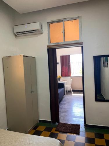 a room with a door open to a living room at APARTAMENTO ZONA COLONIAL R in Santo Domingo