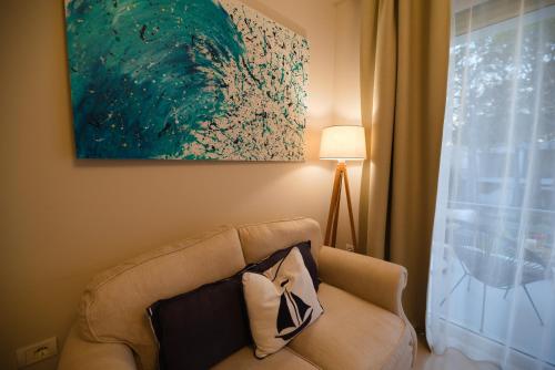 a living room with a couch and a window at Casa Lura at Gjiri i Lalzit, San Pietro Beach in Durrës