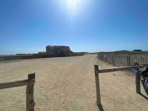 a fence in the middle of a dirt field at Torreilles-Casa terracota-plage - visa image- les déferlantes le Barcares - South of France in Torreilles