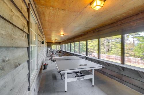 a ping pong table in a room with windows at Greers Ferry Hideaway Lake View, Boat Ramp Access in Fairfield Bay