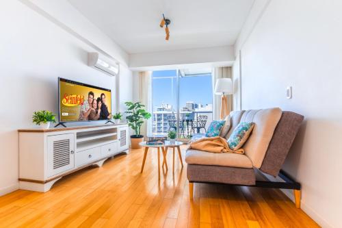 a living room with a tv and a couch at Modern&New Apartment in Palermo - by BueRentals in Buenos Aires