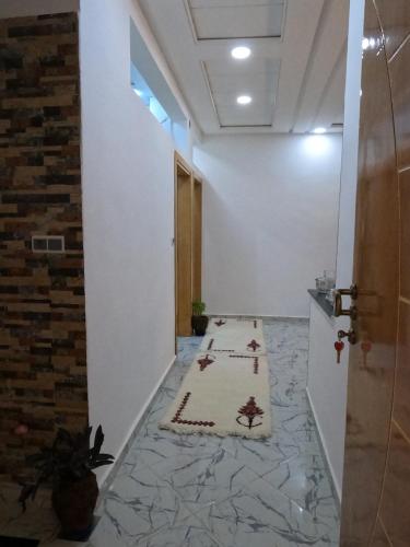 a hallway with a prayer rug on the floor at Tislite d azrou in Azrou