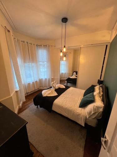 a bedroom with a bed and a window at Central Jesmond 3BD Apt, Parking, Nr Newcastle in Jesmond