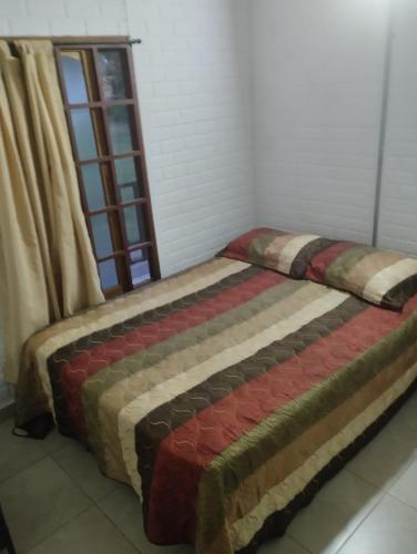 1 cama en una habitación con ventana en Cabañas villa Luz, en Armenia