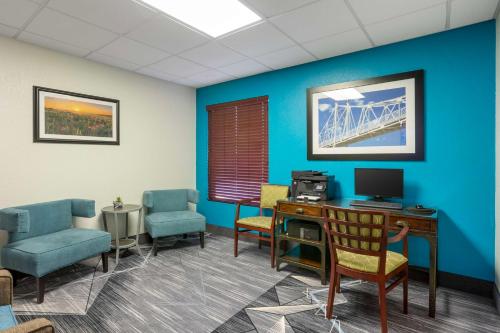 a waiting room with a desk and chairs and a bridge at Best Western Plus Springfield Airport Inn in Springfield