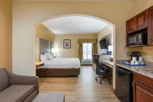 a hotel room with a bed and a desk at Best Western Plus Springfield Airport Inn in Springfield