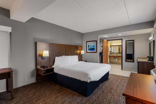 a hotel room with a bed and a bathroom at Best Western Bridgeview Hotel in Superior