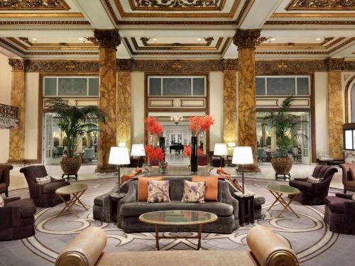 a lobby with a couch and chairs and tables at Fairmont San Francisco in San Francisco