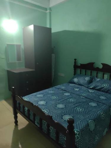 a bedroom with a bed and a dresser at The Ultimate Escape in Soufrière
