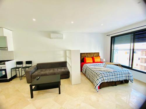 1 dormitorio con 1 cama y 1 sofá en Quiet Top-Floor Studio by Med Faculty & Tram Lines, en Casablanca