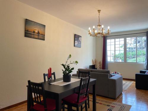 a living room with a table and a couch at Vigário House in Câmara de Lobos