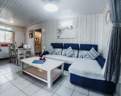 a living room with a couch and a table at Lagoon Dream in Moorea