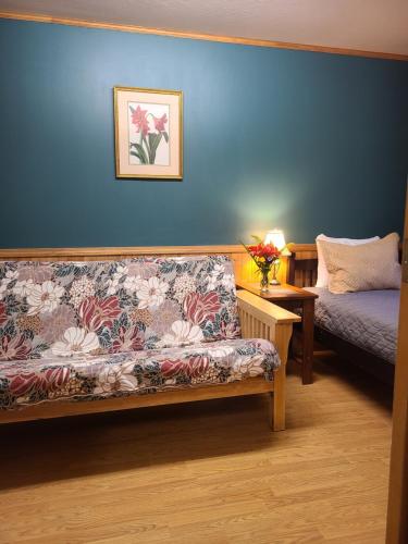 a living room with a couch and a bed at Fern River Resort in Felton