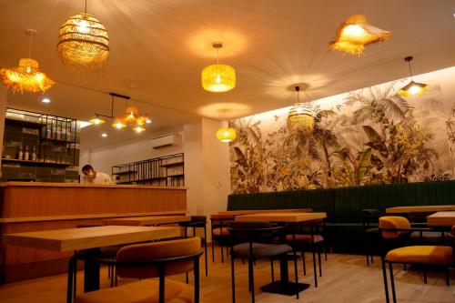 a restaurant with tables and chairs and a chef in the background at HOTEL HIBA in Nouakchott