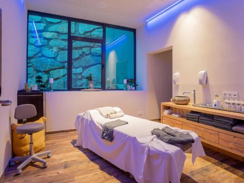 a hospital room with a bed and a window at Chalet H XL in Königsleiten