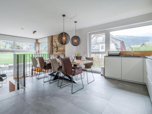 a kitchen and dining room with a table and chairs at Aquarius Haus 7 TOP 16 in Sankt Lorenzen ob Murau