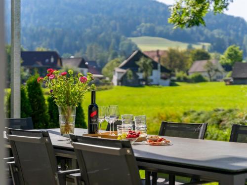 a table with a bottle of wine and glasses at Aquarius Haus 7 TOP 16 in Sankt Lorenzen ob Murau