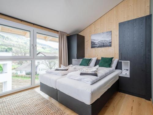 a large bed in a room with a large window at Aquarius Haus 8 TOP 17 in Sankt Lorenzen ob Murau