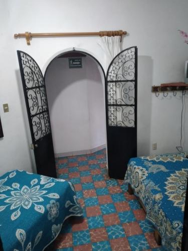 Postel nebo postele na pokoji v ubytování Hotel Las Palomas