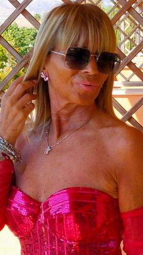 a woman wearing sunglasses talking on a cell phone at La Casa Di Miri in Foligno