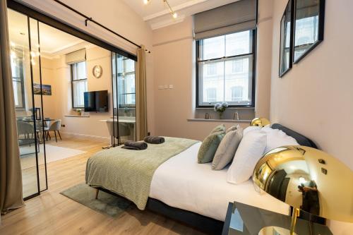 a bedroom with a bed with a helmet on it at Luxury 2BR Apt In City Centre in Manchester