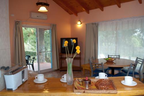 a living room with a table and a dining room with a table and a table at Flor de Lis Casas de Campo in Los Cocos