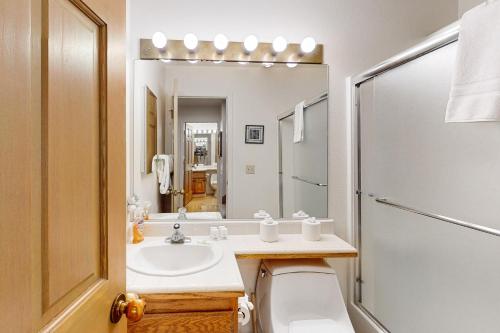 a bathroom with a sink and a toilet and a mirror at View Condo at Northstar in Truckee