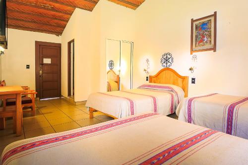 Una cama o camas en una habitación de Hotel Pie de la Sierra
