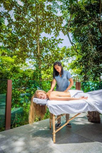 a woman laying on a bed with a woman on it at Chira Glamping Resort Monteverde in Monteverde Costa Rica