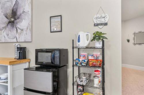 a kitchen with a microwave and a shelf with a television at Villa Luna in Gig Harbor