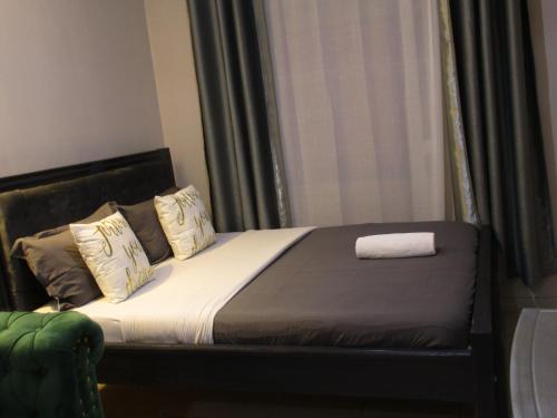 a bed in a room with a window and a pillow at Valley Escapes Homes in Kiambu