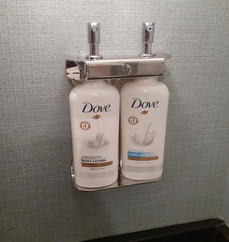 two bottles ofodorizers are hanging on a wall at Holiday Inn Express Selinsgrove by IHG in Shamokin Dam
