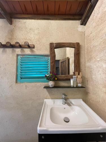 a bathroom sink with a mirror on the wall at HappyZen Farm in Vung Tau