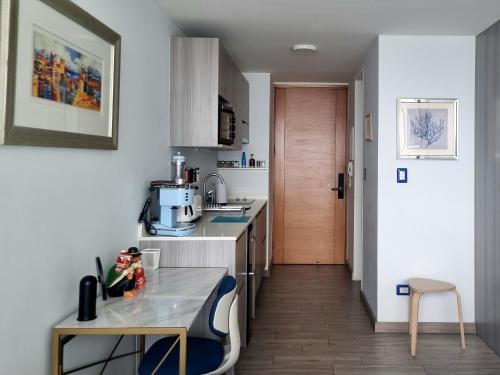 a small kitchen with a counter and a table at Puerto Nuevo Antofagasta - SOLO ADULTOS in Antofagasta