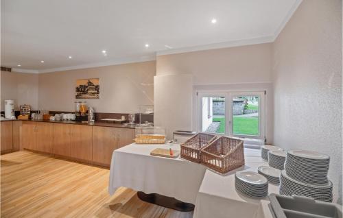 a kitchen with a table and chairs and a counter at Cozy Home In Oberharz With Kitchen in Waldschlösschen