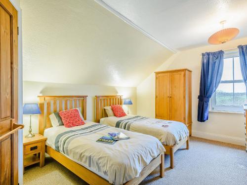 a bedroom with two beds and a window at Beach House in Sea Palling