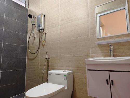 a bathroom with a shower and a toilet and a sink at ALVILLA - Jalan Sultan Ismail in Kuala Terengganu